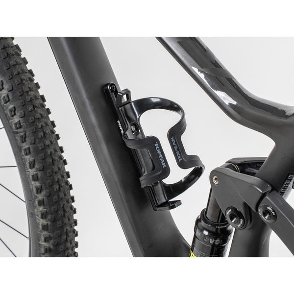 Topeak Bottle Cage with Cage Mount Extender mounted on a bicycle frame, designed for secure water bottle storage.