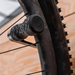 Lezyne bike display mount with CNC alloy wheel hook for bicycle stands and storage, showcasing durable metal construction.