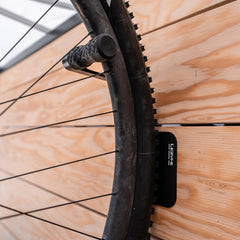 Lezyne bike display mount with CNC alloy wheel hook for bicycle storage and stand organization.