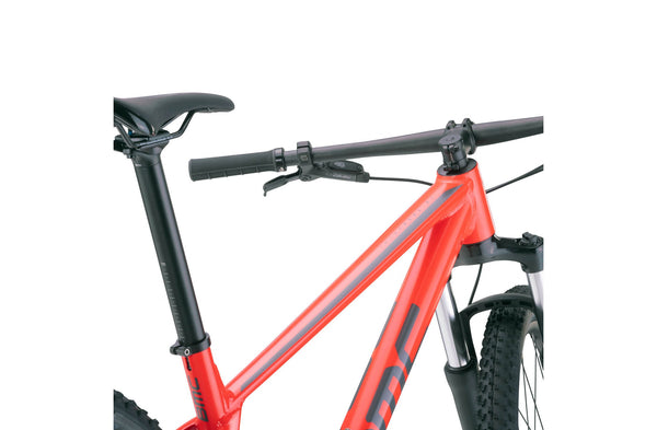BMC Twostroke AL Four 2022 mountain bike with neon red and grey frame, lightweight MTB bike for off-road riding.