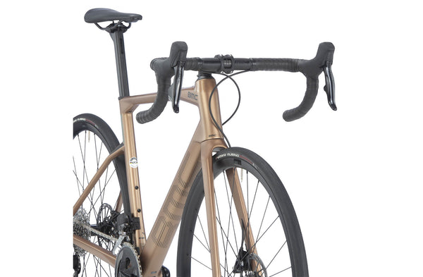 BMC Road Machine FOUR 2023 road bike with brown frame, lightweight design, and drop handlebars, perfect for road cycling enthusiasts.
